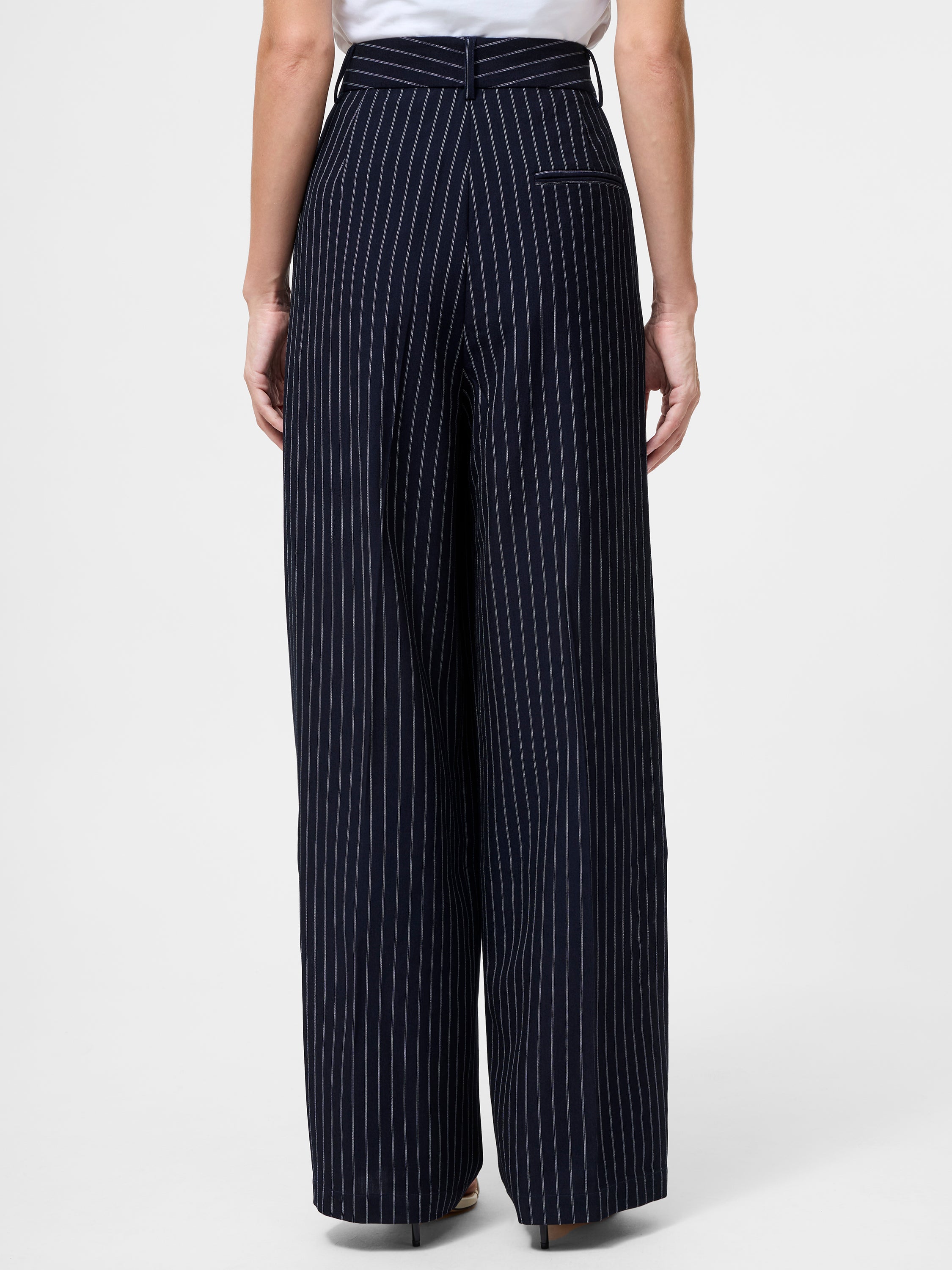 A person is shown from the back wearing Pinstripe Tailored Wide Leg Trousers with white vertical stripes and a single welt pocket on the right, paired with a tucked-in white top.